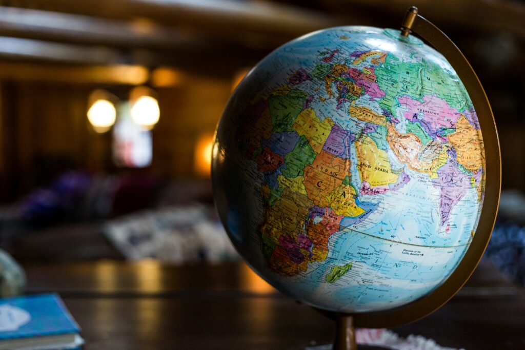 A close-up of a colorful world globe sitting on a table, with Africa, Europe, and the Middle East prominently visible.