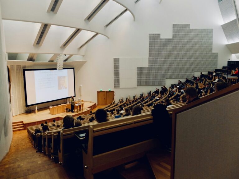 Students sitting in a large university lecture hall, representing the academic goals of students seeking an education consultant in Indore and PGadmit’s AI admissions services.