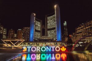 Scholarships in Canada for international students. A nighttime view of the glowing "TORONTO" sign at Nathan Phillips Square.