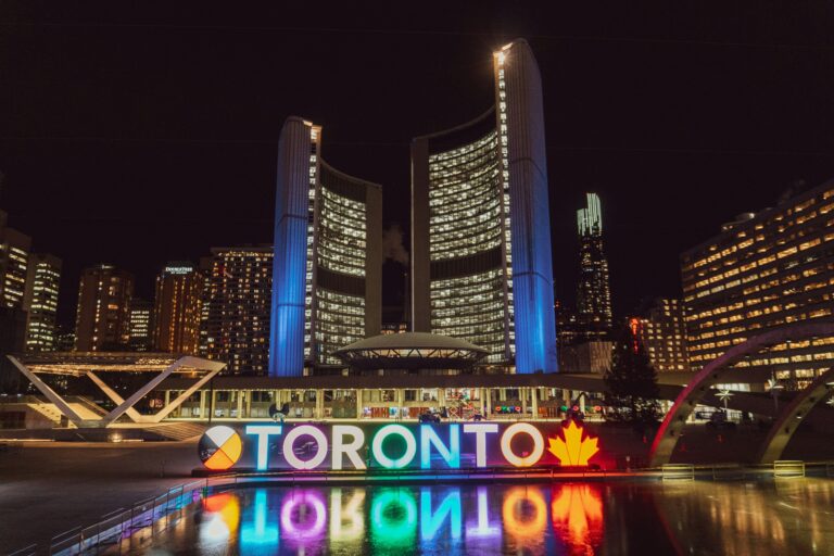 Scholarships in Canada for international students. A nighttime view of the glowing "TORONTO" sign at Nathan Phillips Square.